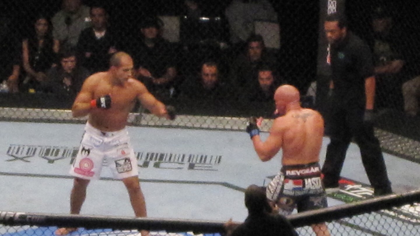 Two MMA fighters facing off inside the cage